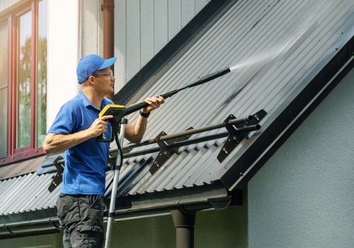 Man using a power washer for Roof Cleaning in Peoria IL