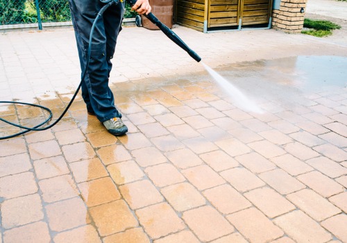 Man cleaning driveway with Power Washing in Peoria IL