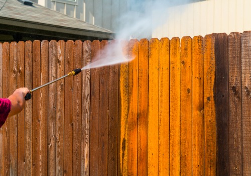 Man using a pressure washing for Fence Cleaning in Peoria IL